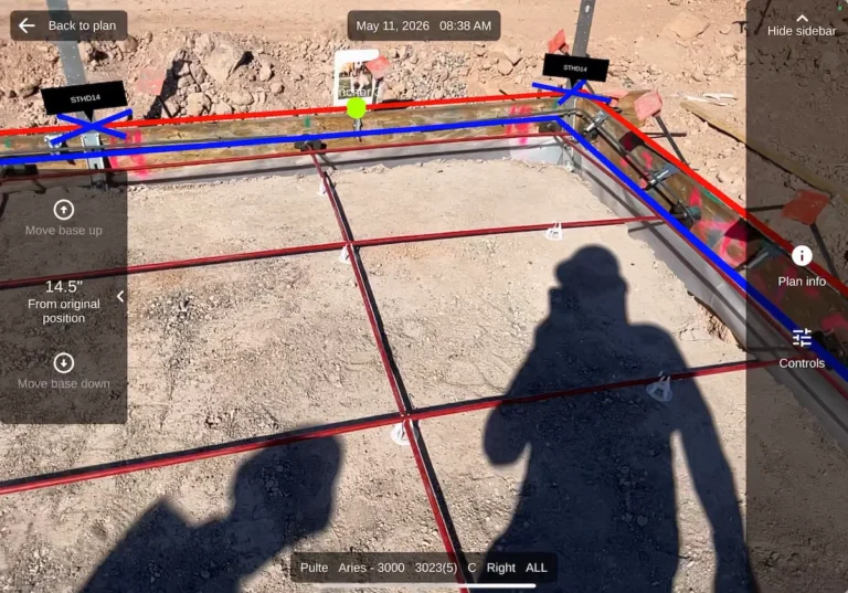 iPad screen displaying PlanMark augmented reality layout software overlaying digital blueprint lines onto a raw dirt residential construction site in bright sunlight.